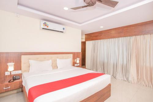 a bedroom with a large bed in a room at Hotel Blue Bell in Bengaluru