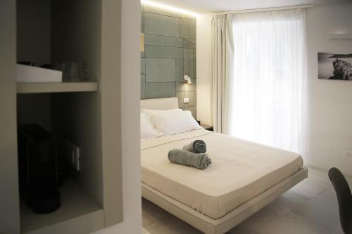 a bedroom with a bed with a towel on it at MADA Charm Apartments Terrace&Carugio in Vernazza