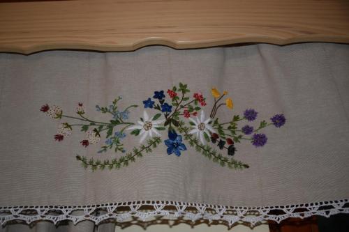 a curtain with a flower design on it at Farm Stay "Alpine Dreams" in Solčava