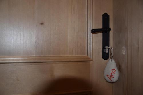 a door with a key and a bag hanging on it at Farm Stay "Alpine Dreams" in Solčava