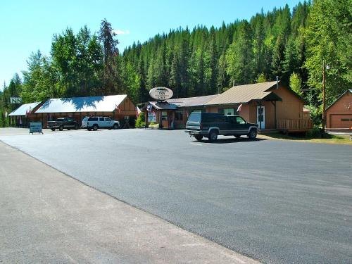 a parking lot with a truck parked in front of a building at Glacier Haven Inn in Pinnacle