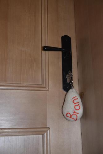 a door with a keychain attached to a door with a lock at Farm Stay "Alpine Dreams" in Solčava