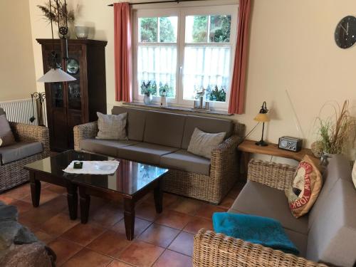 a living room with a couch and a table at "Leuchtturmhaus" by Ferienhaus Strandgut in Born