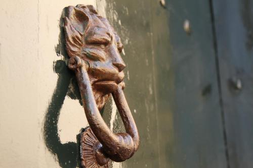 a door knocker on a door with a handle at 4 Balconi rooms-Boutique B&B in Lecce