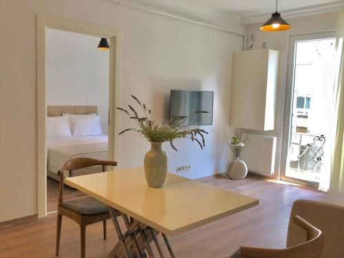 a living room with a table with a vase on it at Joy Suites in Istanbul