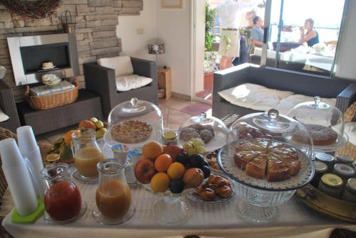 a table with many plates of food on it at Casa tipica siciliana patronale home BedandBreakfast TreMetriSoprailCielo Camere con vista, colazione interna in terrazzo panoramico in Caltagirone