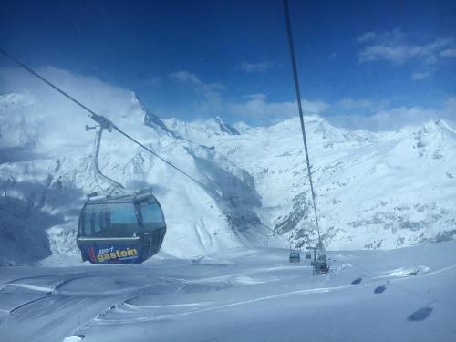 a ski lift going up a snow covered mountain at Ski Lodge Jaktman in Bad Gastein