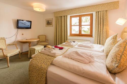 a hotel room with a bed with towels on it at Haus 7 Stuben in Stuben am Arlberg