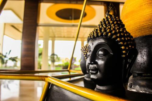 a statue of a head on a chair at Solitaire Hotel And Resorts in Ujjain