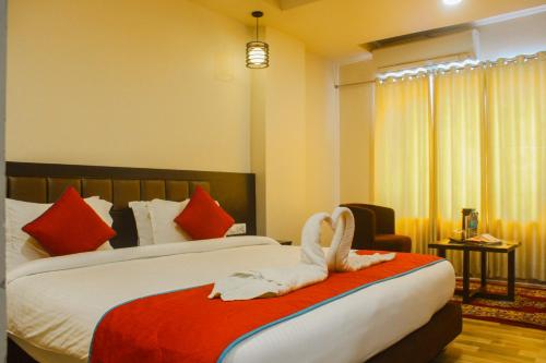 a hotel room with a bed with a bird on it at Solitaire Hotel And Resorts in Ujjain