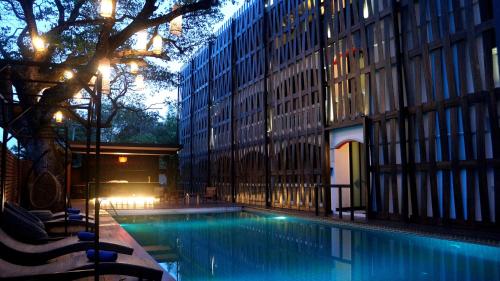 a swimming pool in the middle of a building at Bamboori Boutique Resort in Chiang Mai