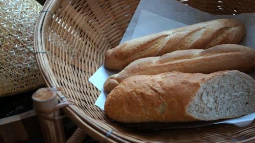 three loaves of bread sitting in a basket at Bamboori Boutique Resort in Chiang Mai