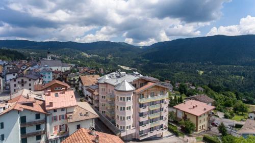 an aerial view of a town with buildings and mountains at Hotel Luna Bianca Folgaria in Folgaria