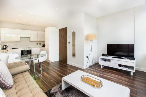 a living room with a couch and a table at City Stay Apartments - Centro in Milton Keynes