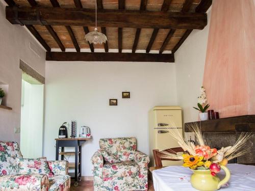 una sala de estar con una mesa con un jarrón de flores en Le Casette Country House 2, en Petricci
