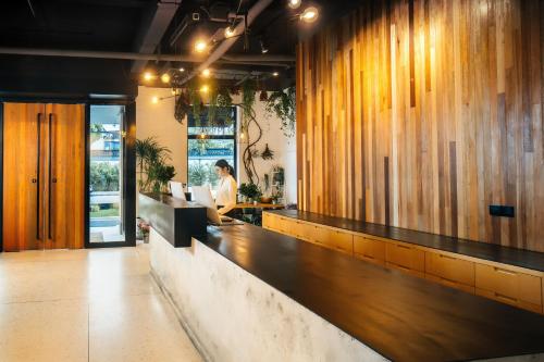 a woman sitting at a counter in a restaurant at Cendre Hotel (Lingering Garden and Tiger Hill) in Suzhou