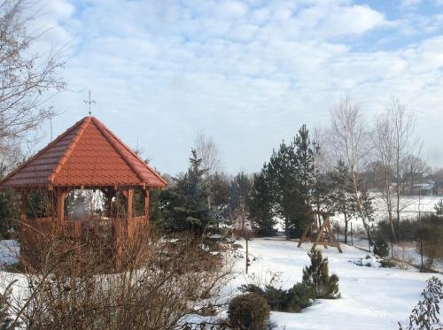 a gazebo with a cross on it in the snow at Ignacówka in Kobyla Góra
