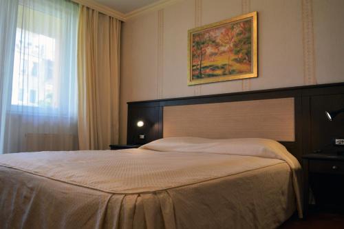 a bedroom with a large bed and a window at Aparthouse Borovo in Sofia