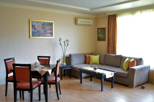 a living room with a couch and a table at Aparthouse Borovo near Bulgaria Mall, free street parking in Sofia