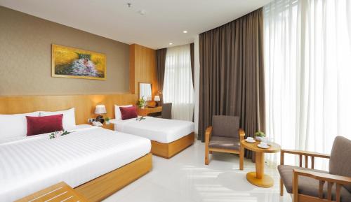 Giường trong phòng chung tại Golda Hotel