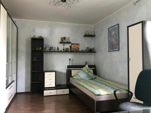 a bedroom with a bed and a mirror at Nice Private Apartments close to Hannover Fairgrounds in Hannover