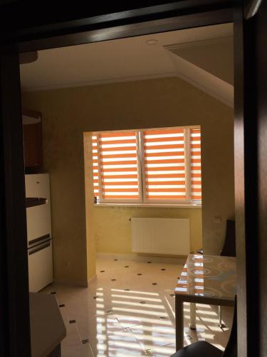a kitchen with a window and a table in a room at Помірецька,9 in Truskavets