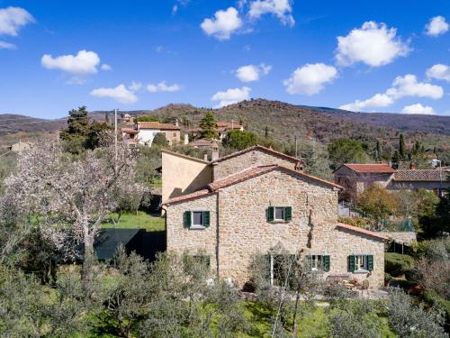 een oud stenen huis in een dorp op een heuvel bij Belvilla by OYO La Noce in Cortona