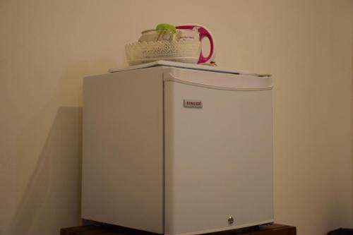 a small refrigerator with a purse on top of it at Sigiri Saman Home Stay in Sigiriya