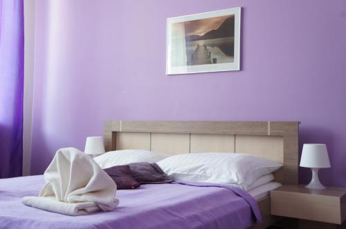 a bedroom with a bed with purple walls at Willa Akacja in Gdynia