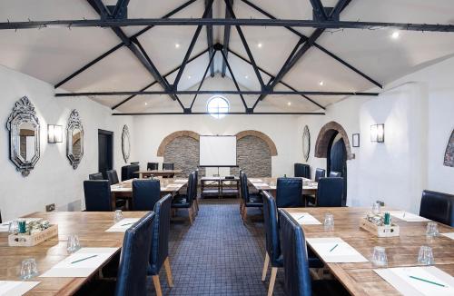 a dining room with wooden tables and chairs at Hotel du Vin Bristol in Bristol