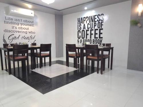 a restaurant with a table and chairs in a room at Hotel Rodolfo in Tacloban