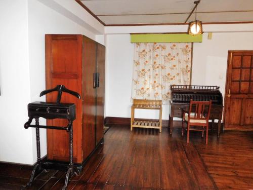 a living room with a piano and a table at The Heritage Club - Tripura Castle Hotel and Spa in Shillong