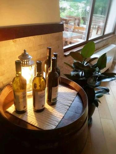 a group of wine bottles sitting on a barrel at Hotel Trebjesa in Nikšić