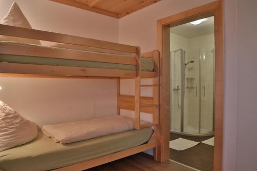a bunk room with a shower and a bunk bed at Haus Burbach in Zellberg
