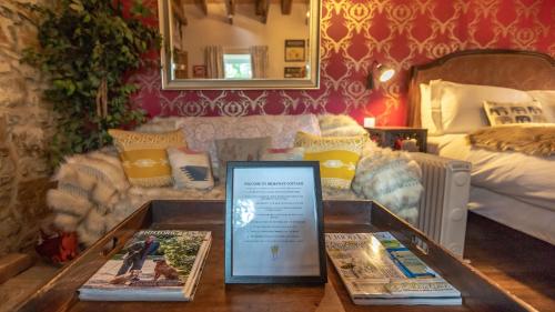 a room with a bed and a table with books at Glamping Bothie in Inverurie