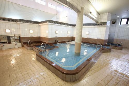 a large swimming pool in a gymnasium with at Free bike & free WIFI 203 Take it easy in Kyoto