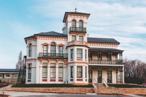 an old house with a tower on top of it at Maylands Lodge in Hobart