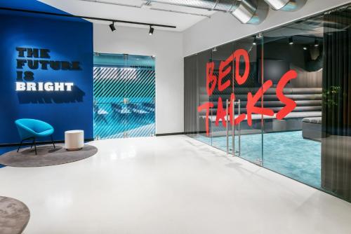 a room with a blue chair and a blue wall at The Social Hub Florence Lavagnini in Florence