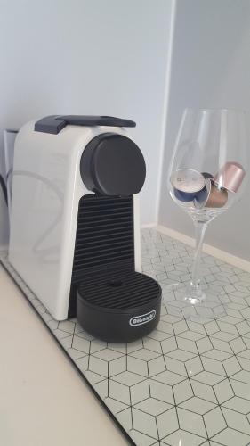 a toaster on a counter next to a wine glass at Privatzeit The green Mile in Leverkusen