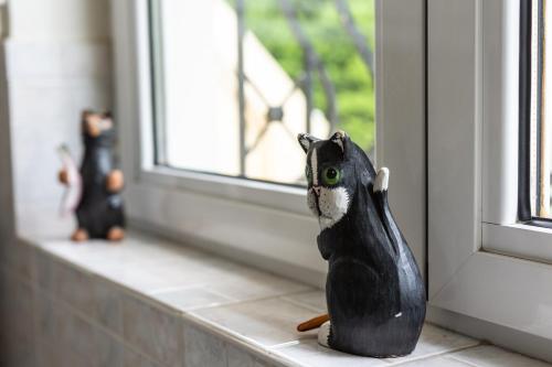a figurine of a black cat sitting on a window sill at Apartments Nina in Athens