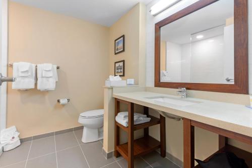 a bathroom with a sink and a toilet at Comfort Inn & Suites in Bowmanville