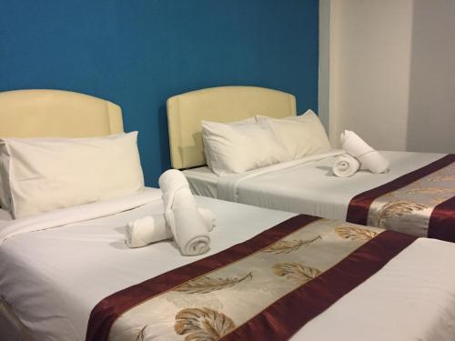 Ένα ή περισσότερα κρεβάτια σε δωμάτιο στο Woodpecker Lodge, Kuching