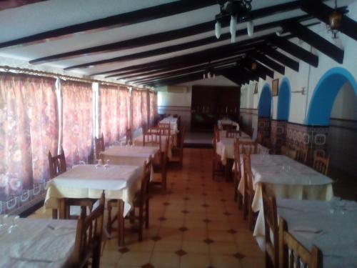 a room with tables and chairs in a restaurant at El Molino in Ruidera