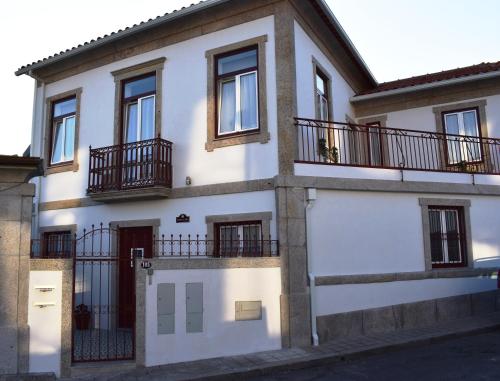 a white house with balconies on the side of it at Oporto Living Apartments in Porto