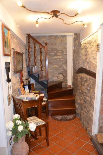 a room with a staircase and a table with a desk at Il Torrione in Castiglione del Lago