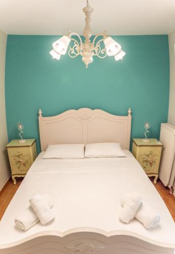 a bedroom with a white bed with two night stands at Apartments Nina in Athens