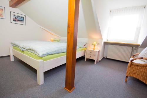 a small bedroom with a bed and a mirror at Ferienhof Andreas Hansen in Rettin