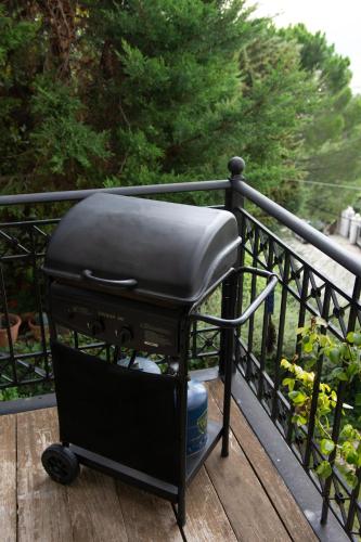 a grill sitting on a railing on a porch at Apartments Nina in Athens