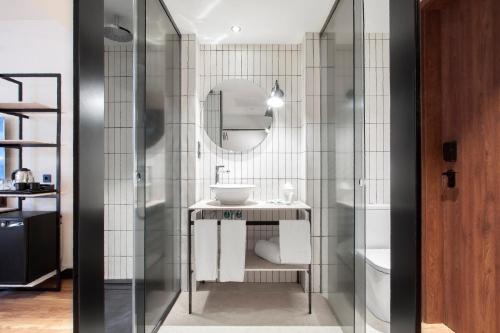 a bathroom with a sink and a mirror at Radisson Blu 1882 Hotel, Barcelona Sagrada Familia in Barcelona