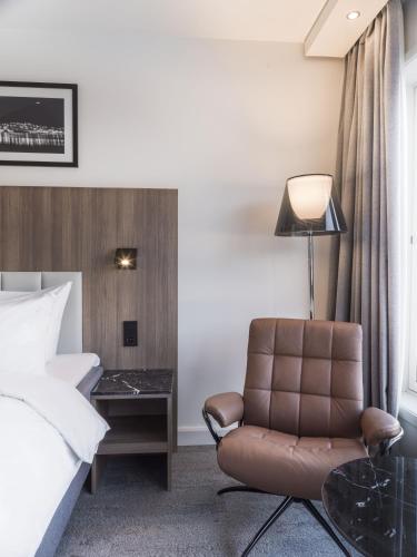 a hotel room with a bed and a chair at Radisson Blu Hotel Tromsø in Tromsø